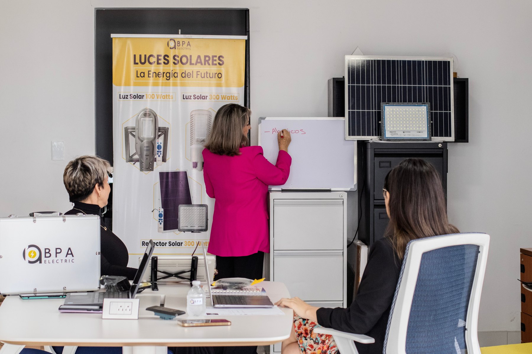 A small group discussing solar-energy solutions during a presentation